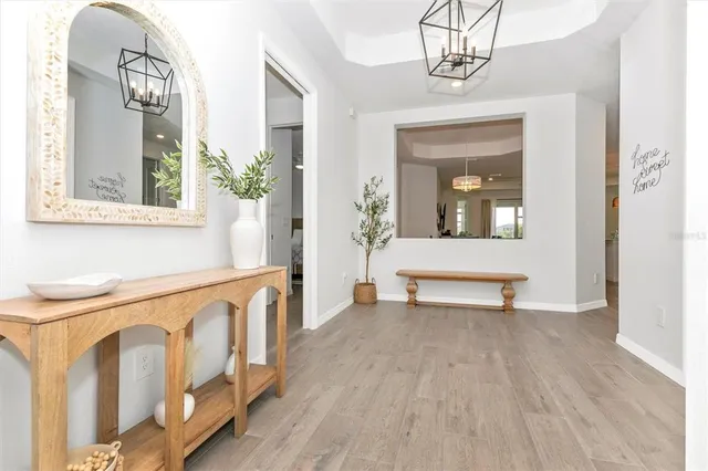 a kitchen with refrigerator and chairs