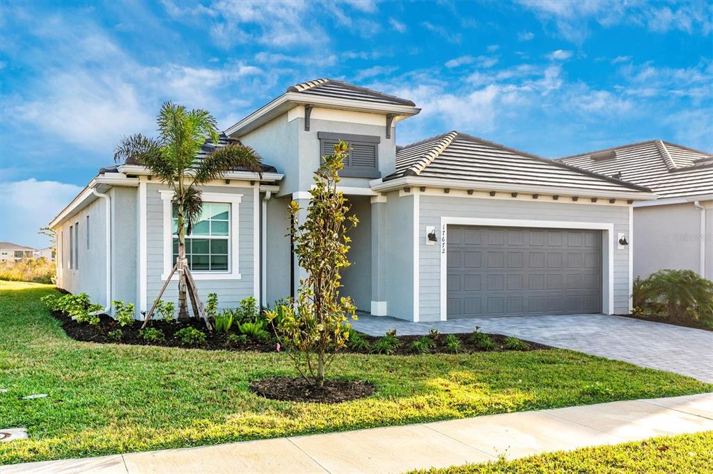17672 Santorini Court Venice, FL 34293 - Photo 42 of 94 a front view of a house with garden
