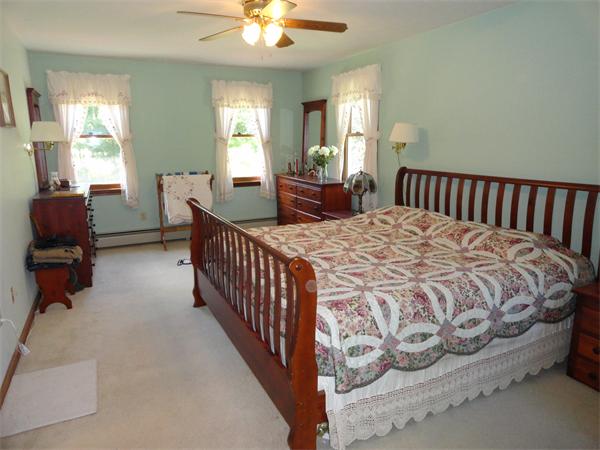156 Fitchburg Road Townsend, MA 01469 - Photo 10 of 17 a bed sitting in a bedroom next to a window