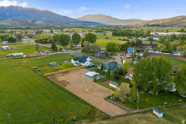 681 Island Road Morgan, UT 84050 - Photo 45 of 49 Expansive property featuring a large equestrian arena, white-sided main residence with a dark roof, and a covered structure