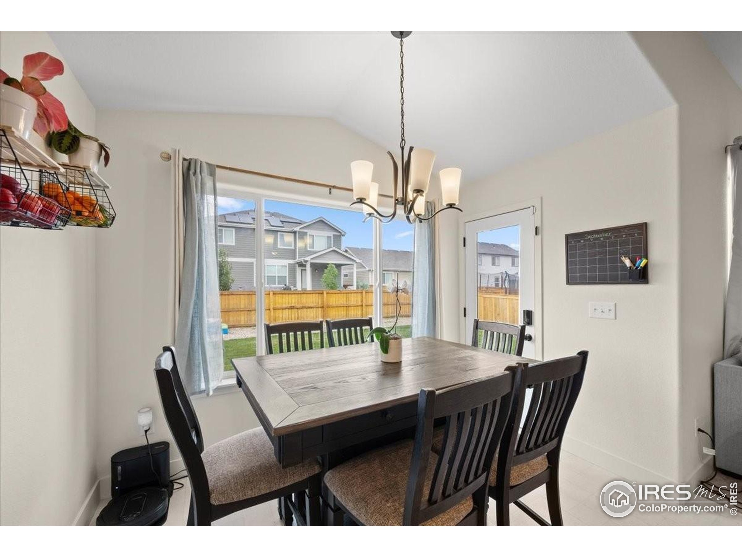 915 Milner Pass Road Severance, CO 80550 - Photo 11 of 20 a view of a dining room with furniture a chandelier and wooden floor