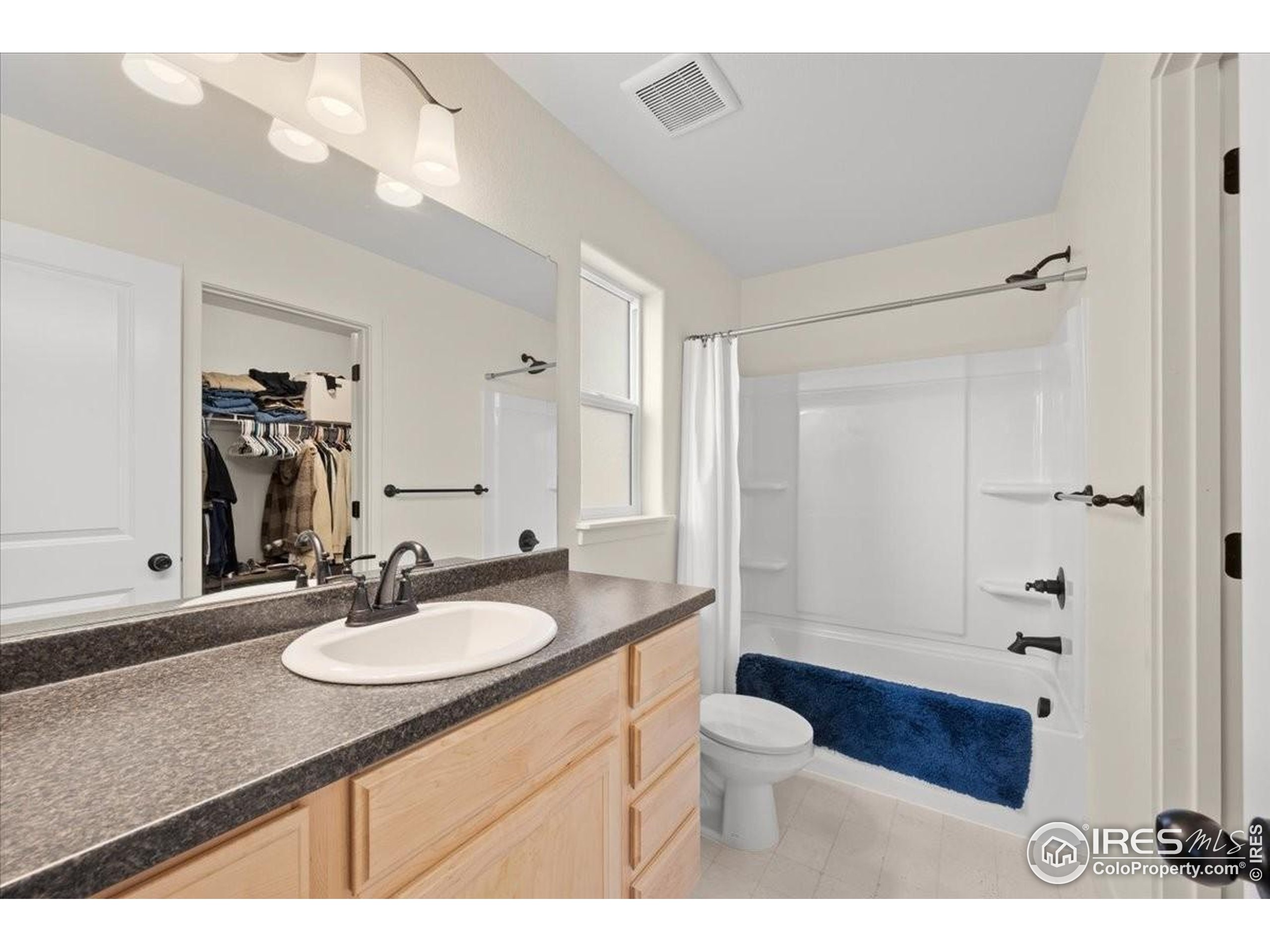 915 Milner Pass Road Severance, CO 80550 - Photo 13 of 20 a bathroom with a granite countertop sink toilet a mirror and shower