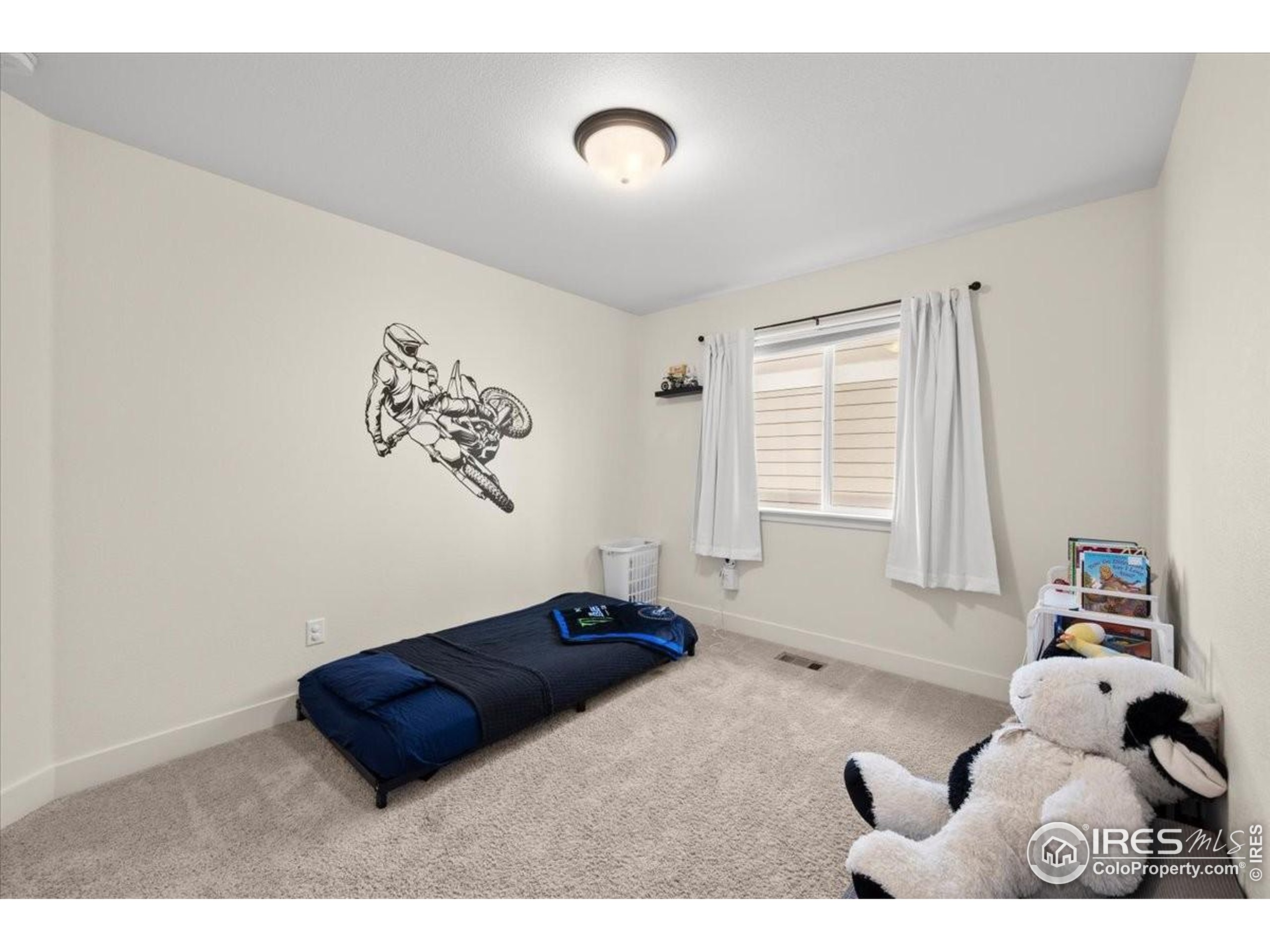 915 Milner Pass Road Severance, CO 80550 - Photo 14 of 20 a bedroom with a bed and a window