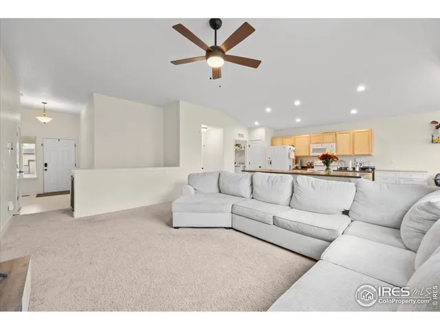 a living room with furniture and kitchen view