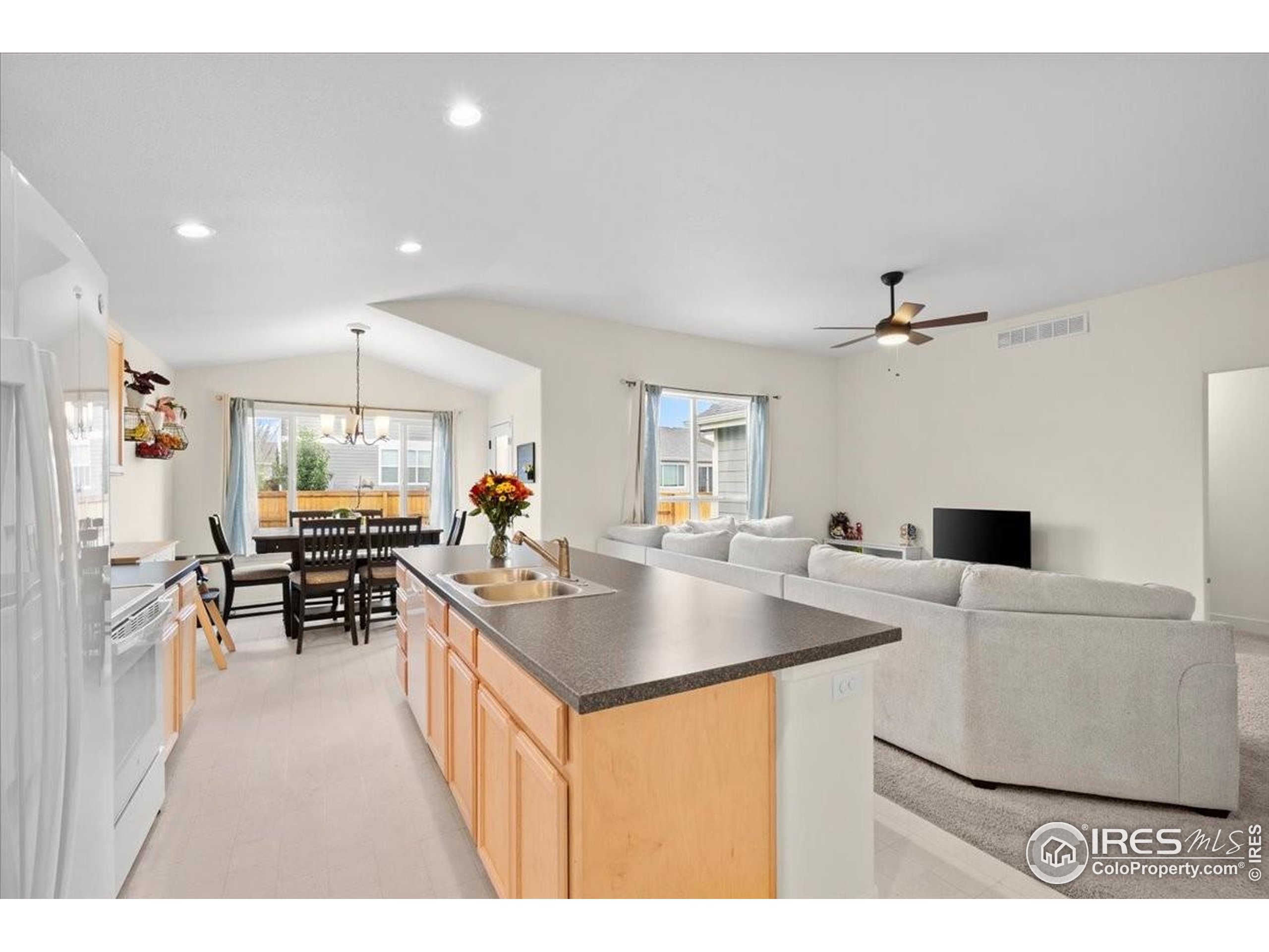 915 Milner Pass Road Severance, CO 80550 - Photo 5 of 20 a kitchen with stainless steel appliances granite countertop a sink a counter top space and cabinets