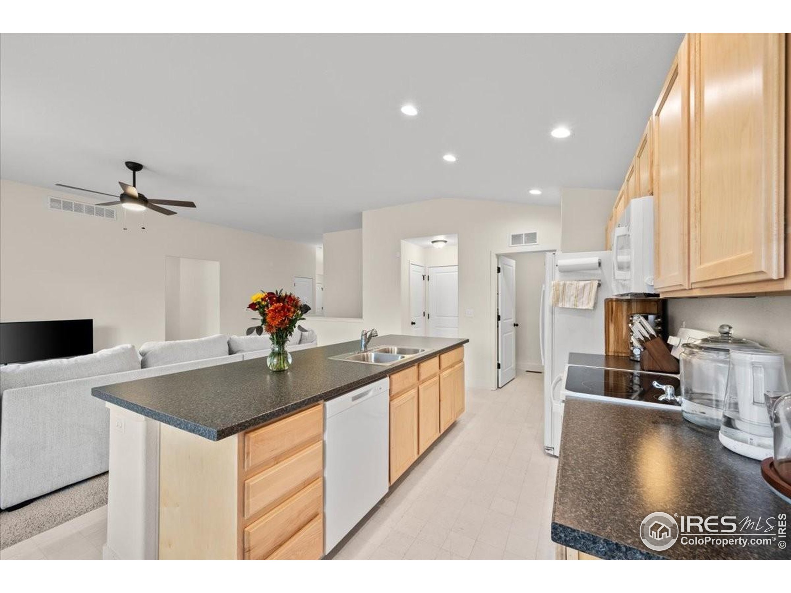915 Milner Pass Road Severance, CO 80550 - Photo 6 of 20 a kitchen with stainless steel appliances granite countertop a sink a stove and a refrigerator