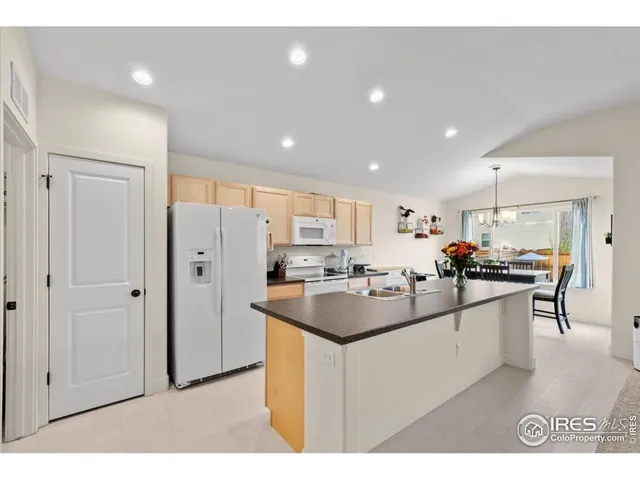 a kitchen with stainless steel appliances a sink stove and refrigerator