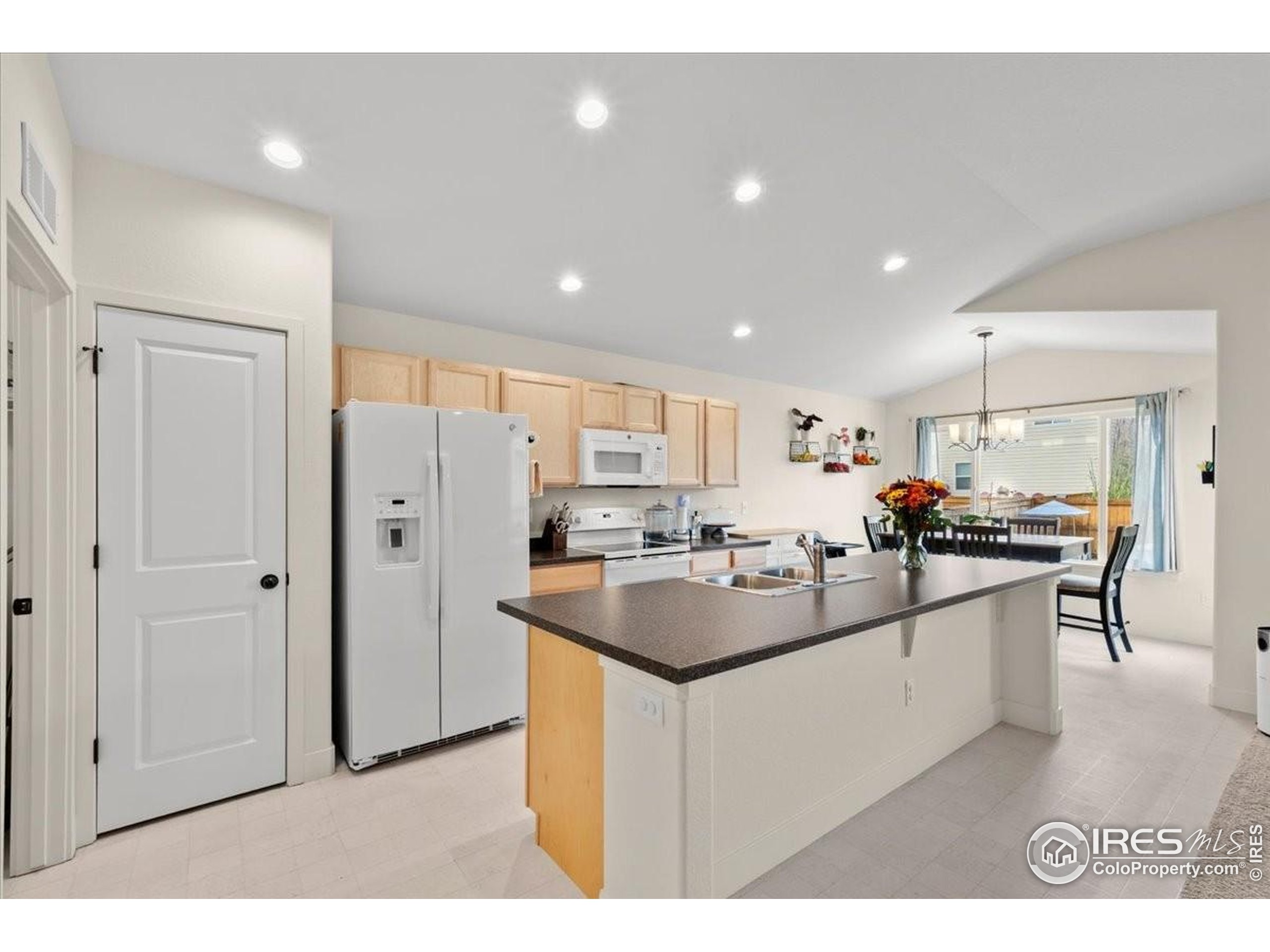 915 Milner Pass Road Severance, CO 80550 - Photo 8 of 20 a kitchen with stainless steel appliances a sink stove and refrigerator