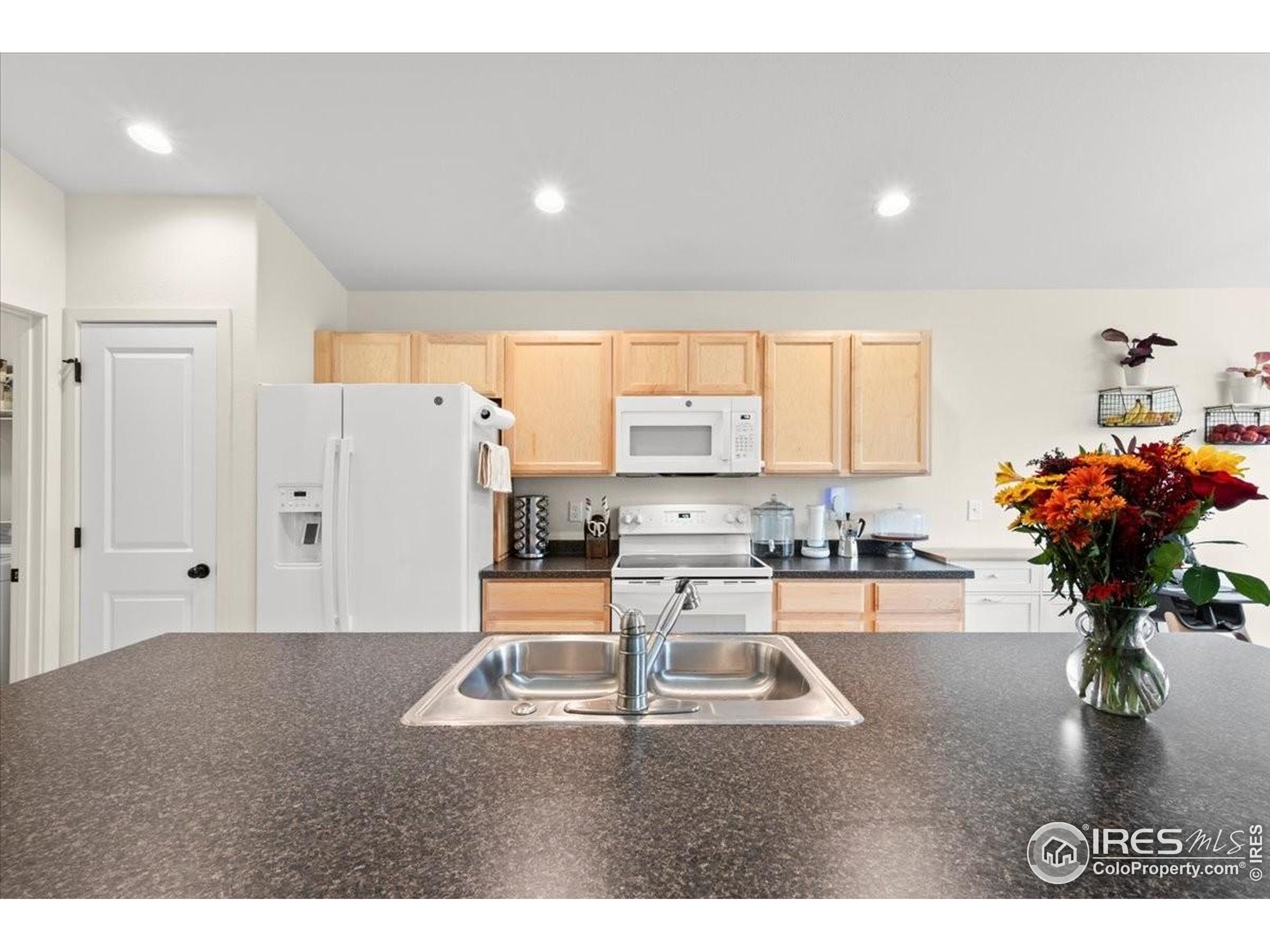 915 Milner Pass Road Severance, CO 80550 - Photo 9 of 20 a living room with furniture a potted plant and a large window