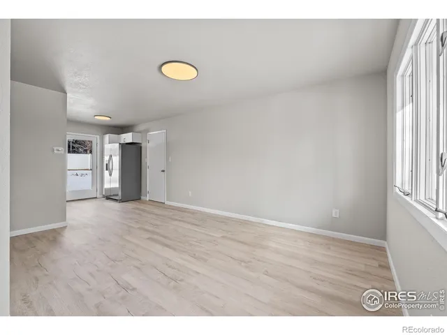 a kitchen with granite countertop white cabinets and stainless steel appliances