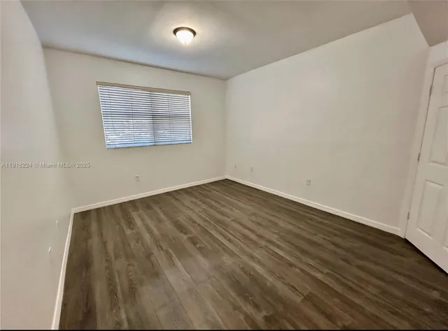 an empty room with wooden floor