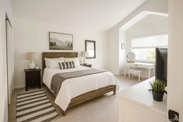 a bedroom with a bed and view of bathroom