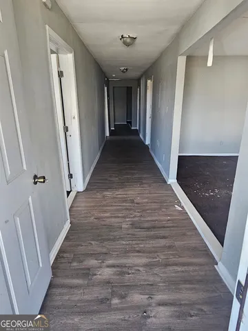 a view of hallway with wooden floor