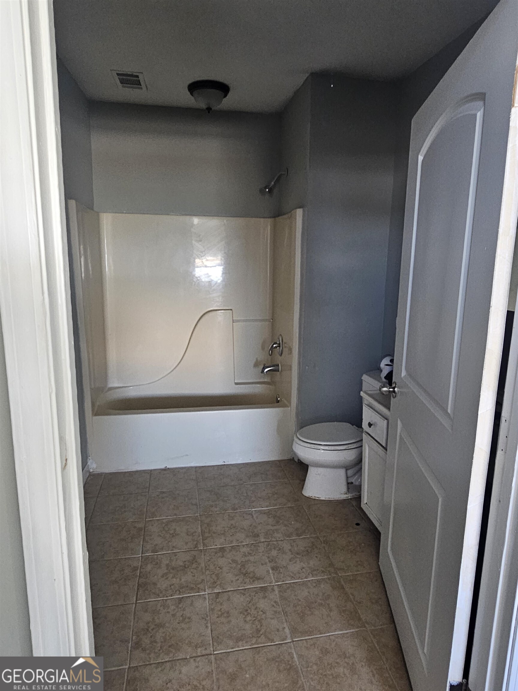 132 Madison Street Macon, GA 31201 - Photo 3 of 4 a bathroom with a toilet and a shower