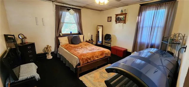 a bedroom with a bed and a chandelier