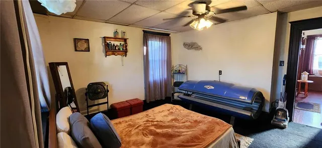 a bed sitting in a bedroom next to a window