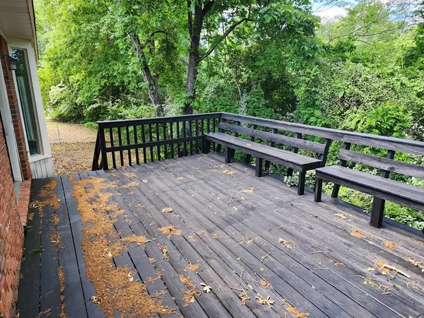 a view of balcony with wooden floor and fence
