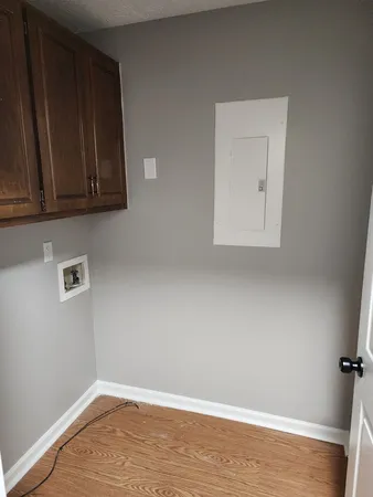 a view of a room with wooden floor and cabinet