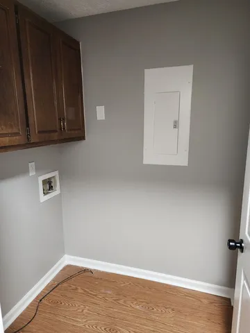 a view of a room with wooden floor and cabinet