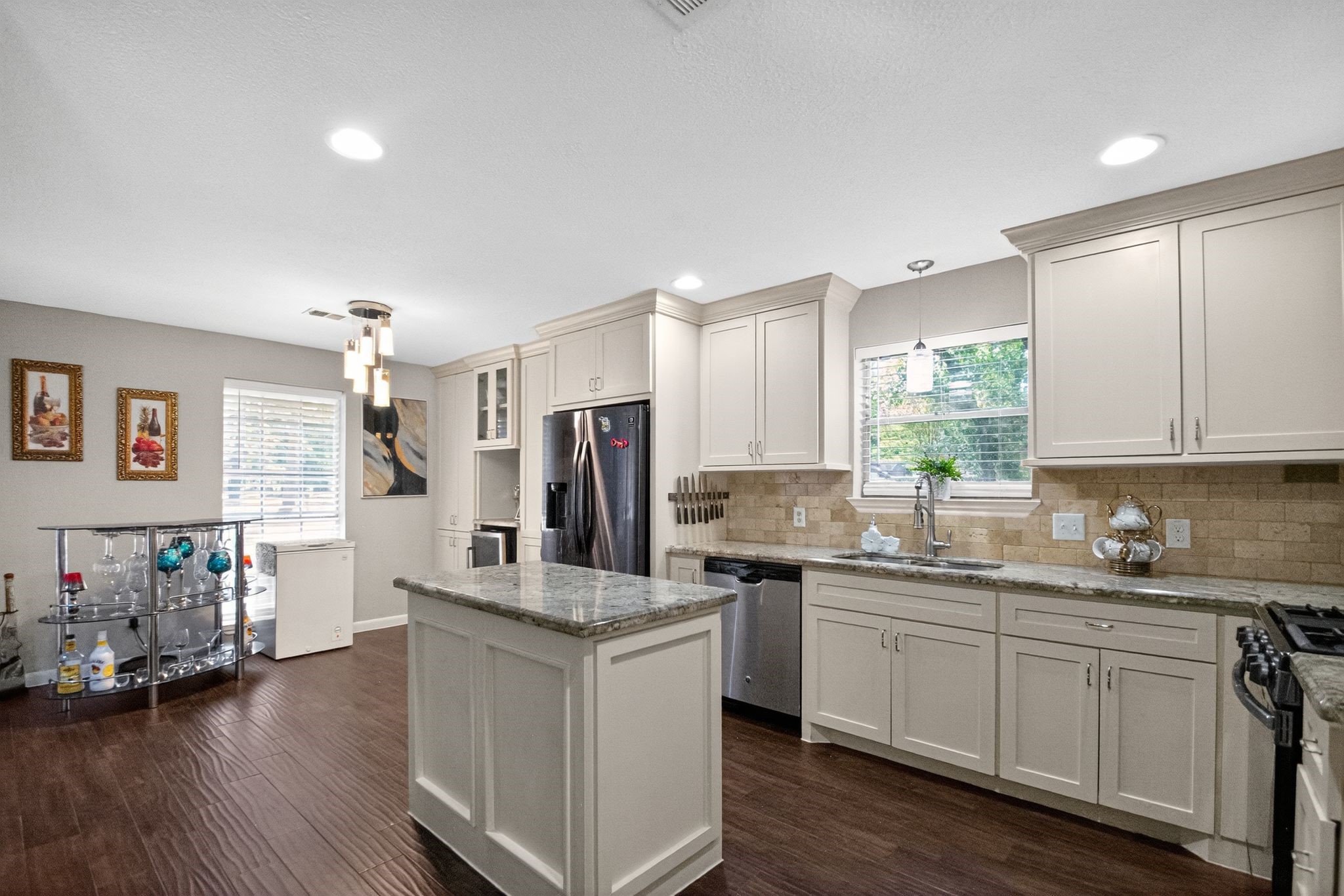 2514 Creekleaf Road Houston, TX 77068 - Photo 19 of 31 Open-concept kitchen with oversized island, marble surfaces, stainless steel appliances, and gas cooking for added convenience.