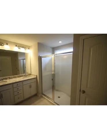 a bathroom with a sink a double vanity and a mirror