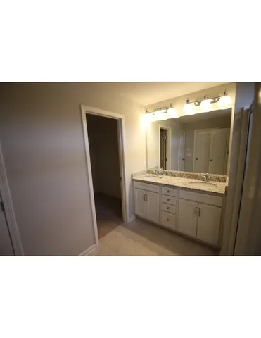 a bathroom with a sink a mirror and a bathtub