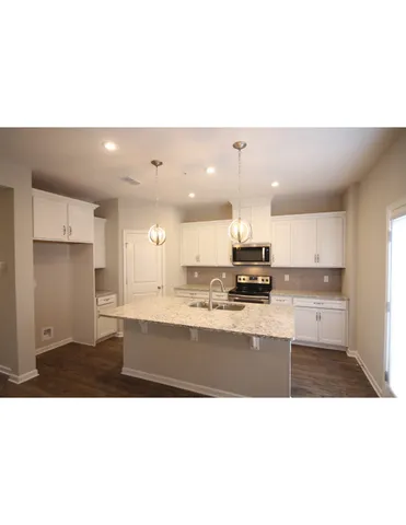 a kitchen with a sink stainless steel appliances and cabinets