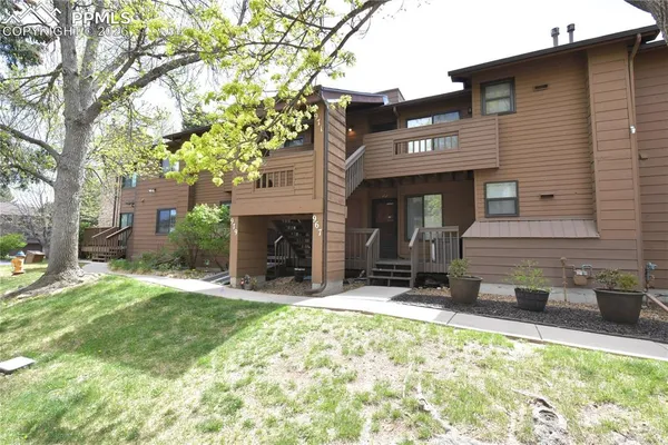 a view of a house with yard and sitting area