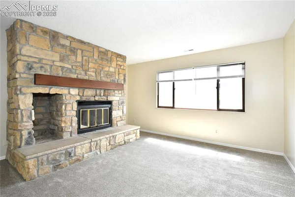 an empty room with a fireplace