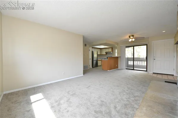 a view of an empty room with a fireplace