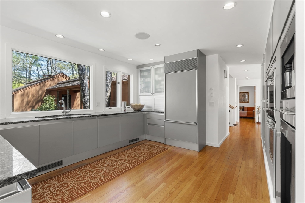 11 Chaplin Road Boxford, MA 01921 - Photo 12 of 42 a kitchen with stainless steel appliances a refrigerator and a wooden floor