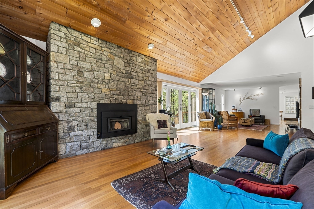 11 Chaplin Road Boxford, MA 01921 - Photo 16 of 42 a living room with furniture a fireplace and a dining table