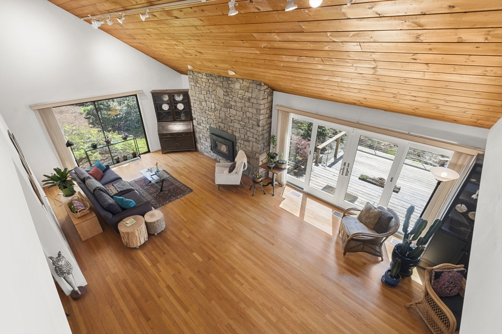 11 Chaplin Road Boxford, MA 01921 - Photo 17 of 42 a living room with furniture floor to ceiling window and a wooden floor