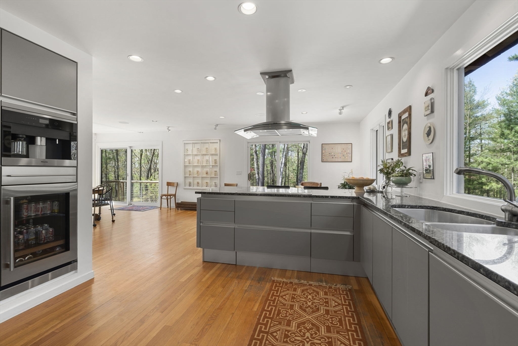 11 Chaplin Road Boxford, MA 01921 - Photo 9 of 42 a kitchen with stainless steel appliances granite countertop a sink a stove and a wooden floors