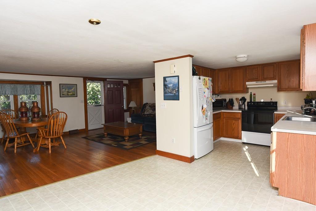 156 Indian Neck Road Wareham, MA 02571 - Photo 3 of 18 a kitchen with furniture a refrigerator and wooden floor