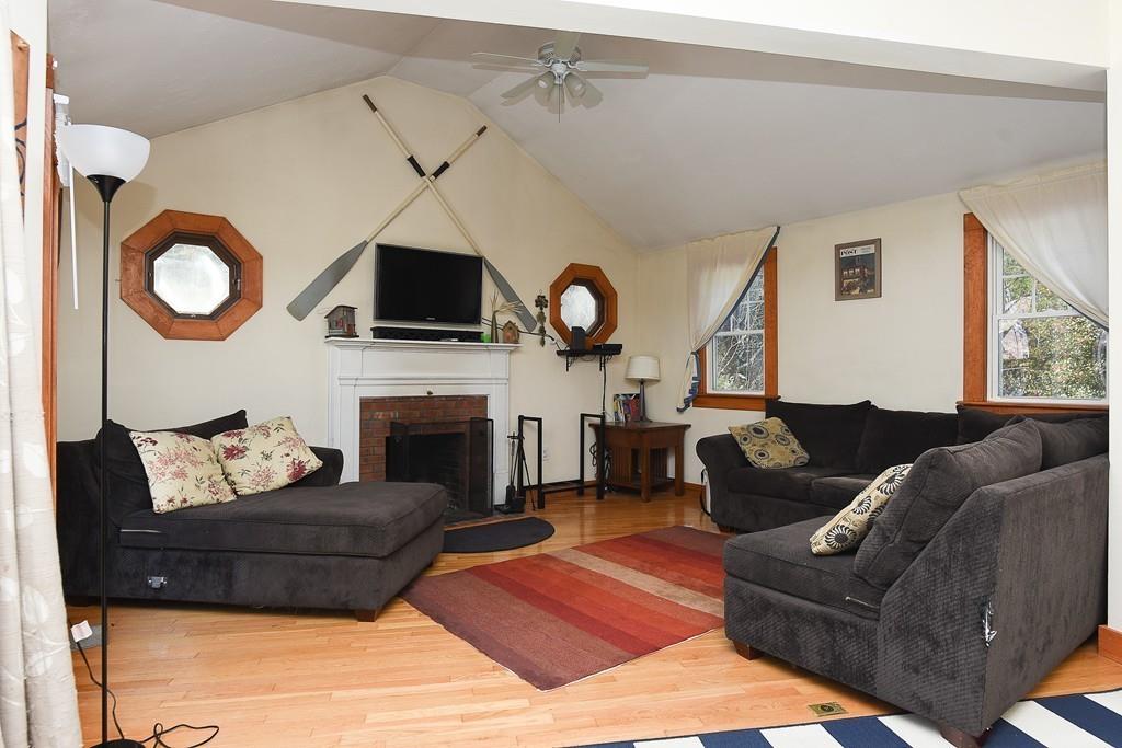 156 Indian Neck Road Wareham, MA 02571 - Photo 8 of 18 a living room with furniture a flat screen tv and a fireplace