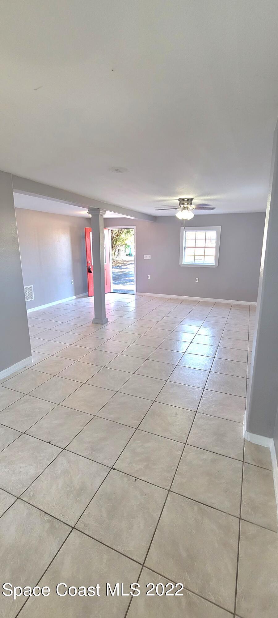 802 Forrest Avenue, Unit A Cocoa, FL 32922 - Photo 7 of 16 a view of a hallway with window and chandelier fan