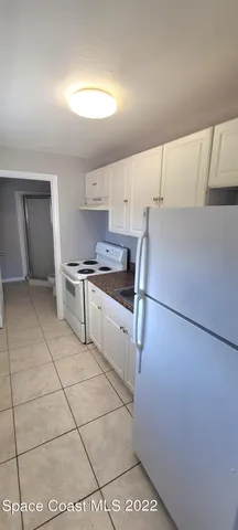 a kitchen with a sink a stove and refrigerator