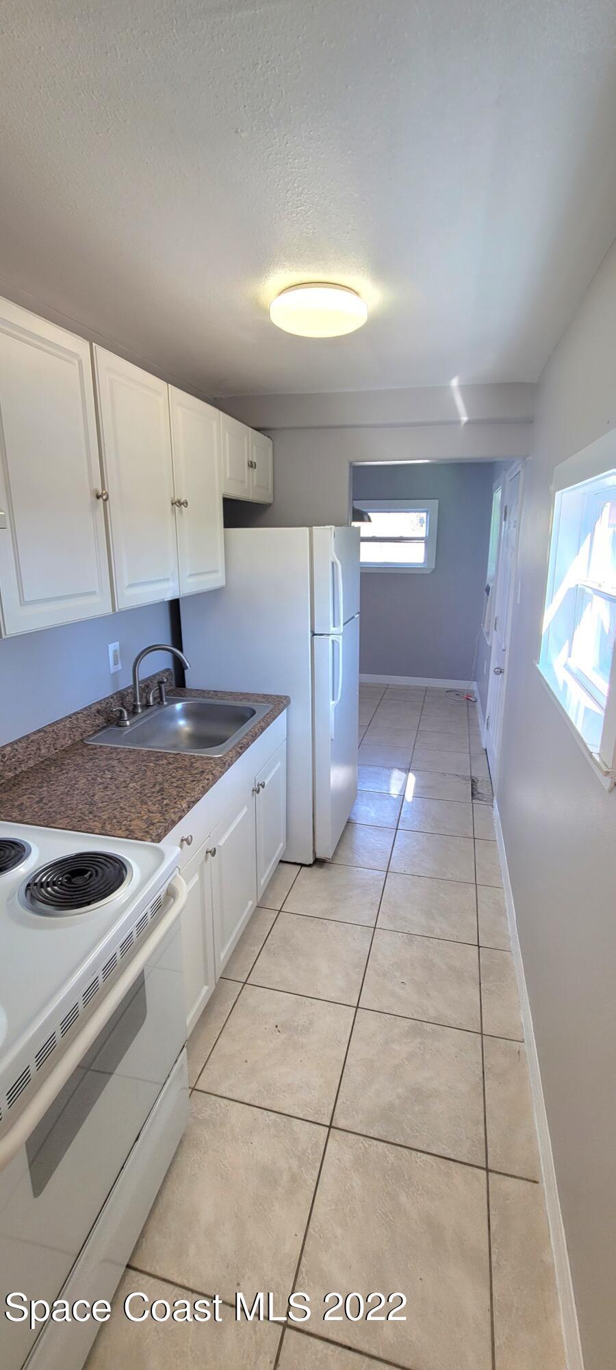 802 Forrest Avenue, Unit A Cocoa, FL 32922 - Photo 9 of 16 a kitchen with a sink and cabinets
