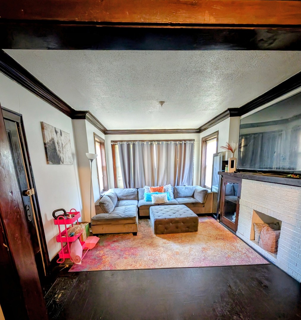 9035 South Bishop Street Chicago, IL 60620 - Photo 3 of 5 a bedroom with furniture and a fireplace