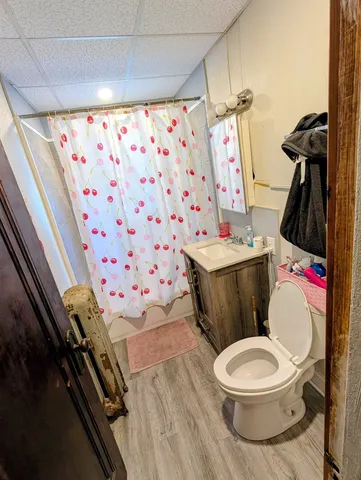 a white toilet sitting next to a bathroom sink and a mirror
