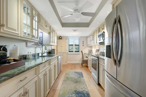 a kitchen with stainless steel appliances granite countertop a refrigerator and a sink