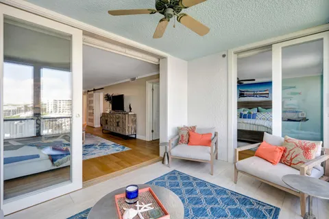 a living room with furniture and a floor to ceiling window