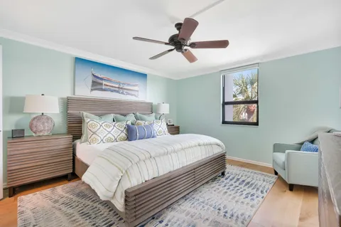 a bedroom with a bed and wooden floor