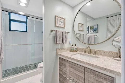 a bathroom with a double vanity sink and a mirror