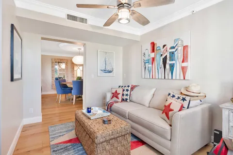 a living room with furniture and a painting on the wall