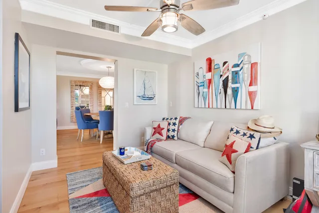 a living room with furniture and a painting on the wall