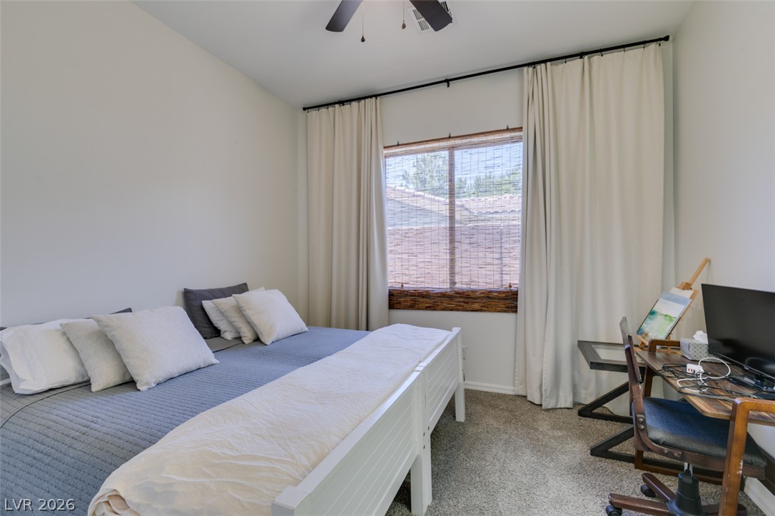 8 Kennesaw Road Henderson, NV 89052 - Photo 27 of 44 A comfortable bedroom with a window offering glimpses of the outside, creating a serene personal retreat.