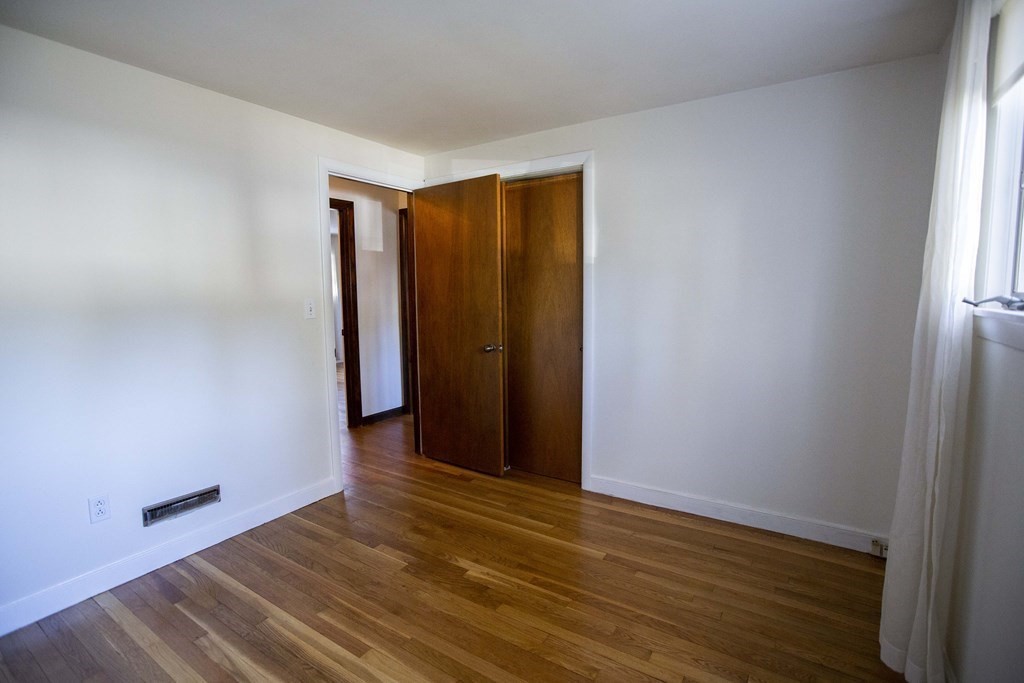 69 Sturges Road Reading, MA 01867 - Photo 13 of 42 an empty room with wooden floor and closet