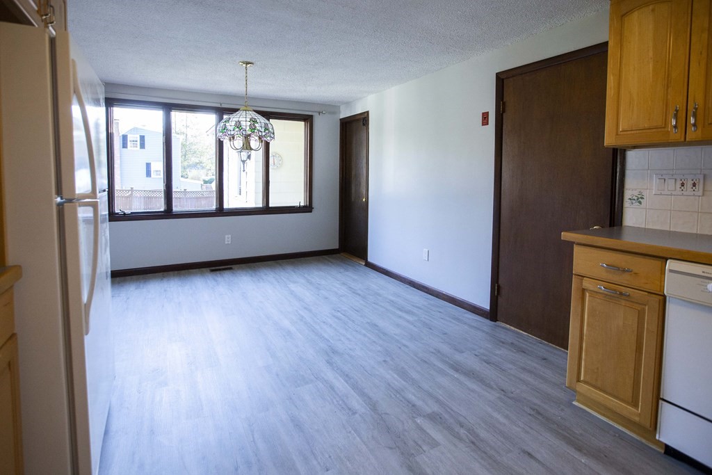 69 Sturges Road Reading, MA 01867 - Photo 16 of 42 an empty room with wooden floor and windows